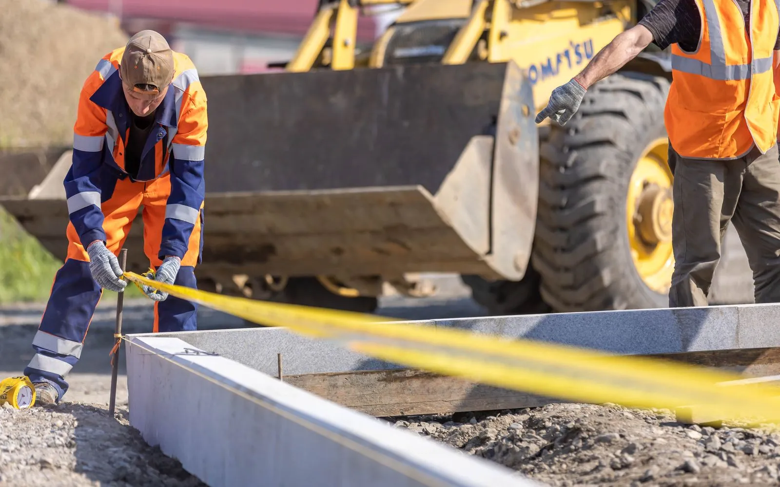 A tradesperson measuring up on a UK building site